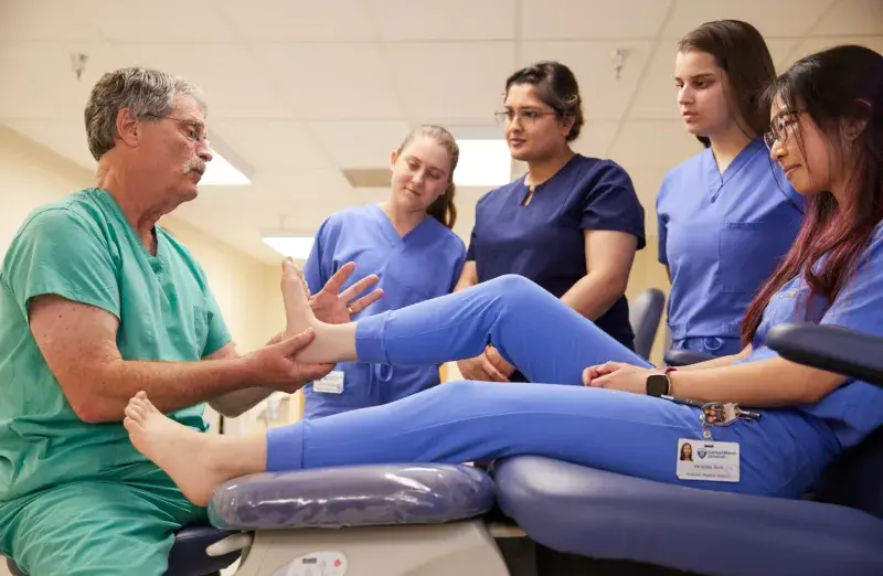 Podiatry professor teaching students in SMU biomechanics lab